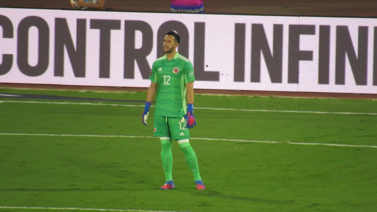 Camilo Vargas con el uniforme verde de portero de Colombia y el número 12, de pie sobre la cancha durante un partido